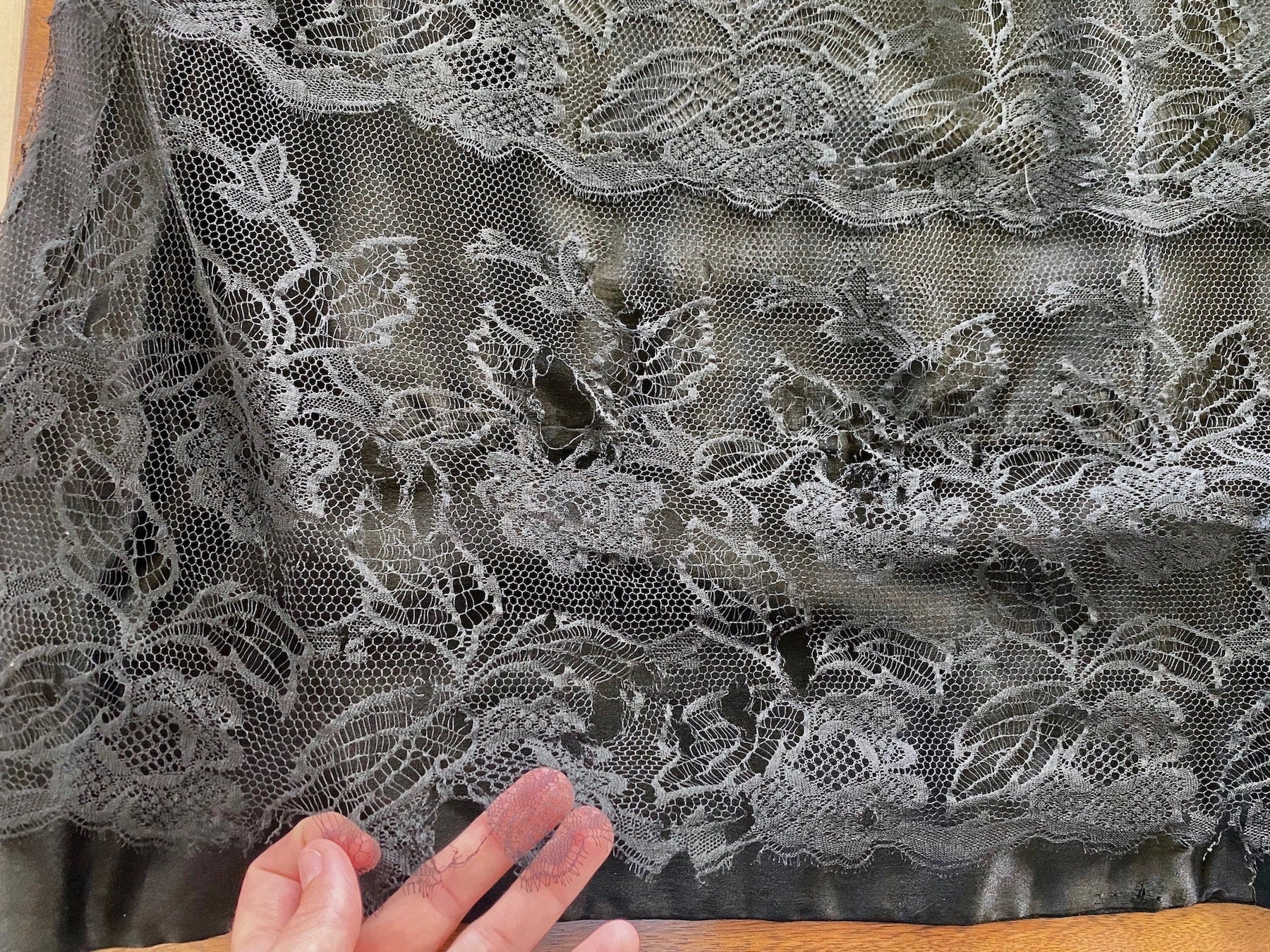 Close-up of lace showing some tears / holes