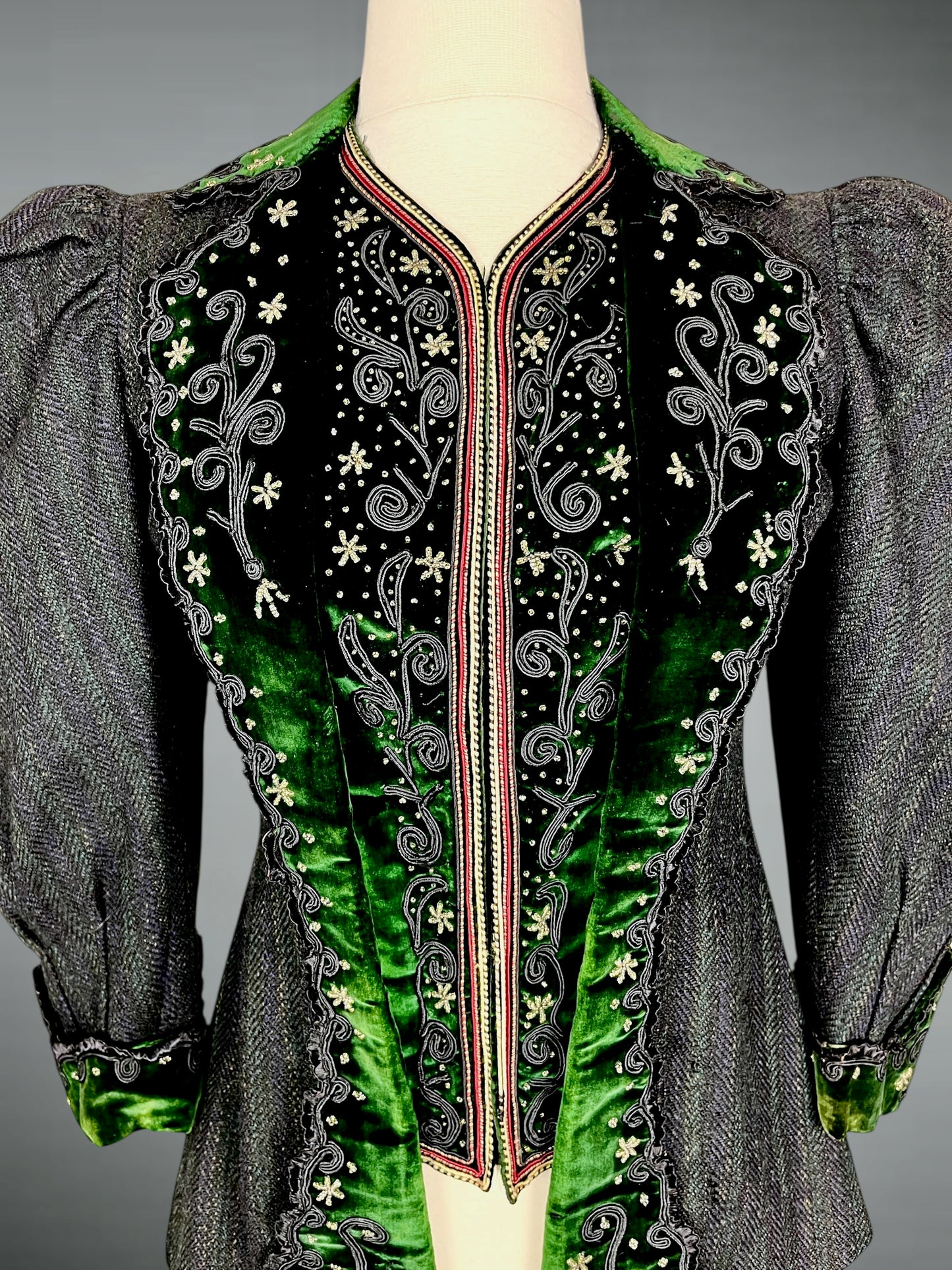 Detail of emerald green velvet trim with soutache embroidery and beaded snowflake motifs on Victorian bodice