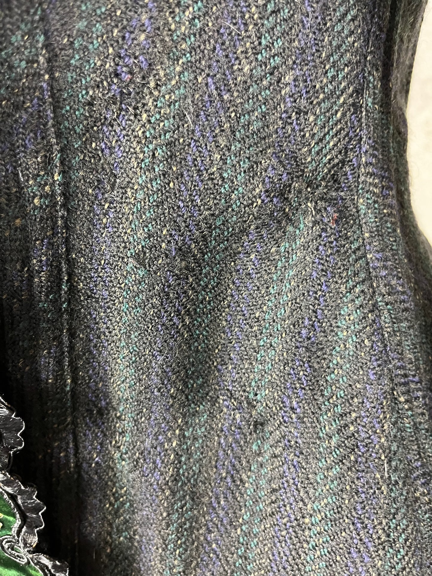 Close-up of striped wool fabric with darning