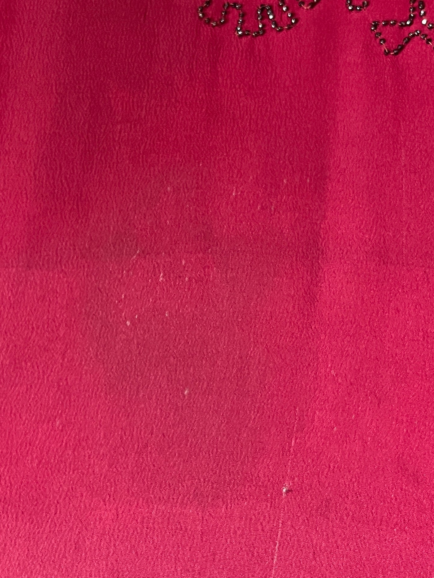 close-up of tiny wear to silk on skirt and faint shade