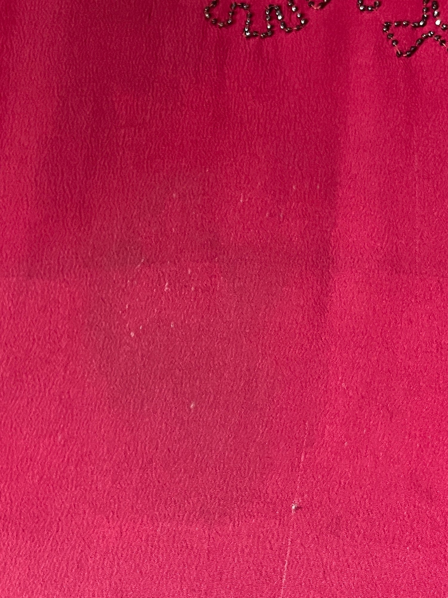 close-up of tiny wear to silk on skirt and faint shade