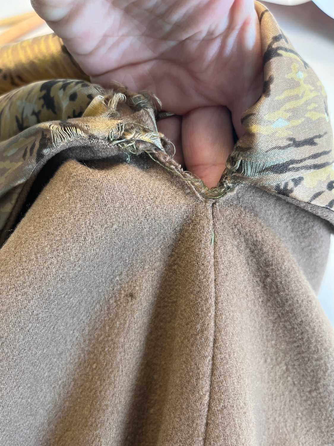 close-up of outer underarm - silk lining wear/tear and needs some hand stitches