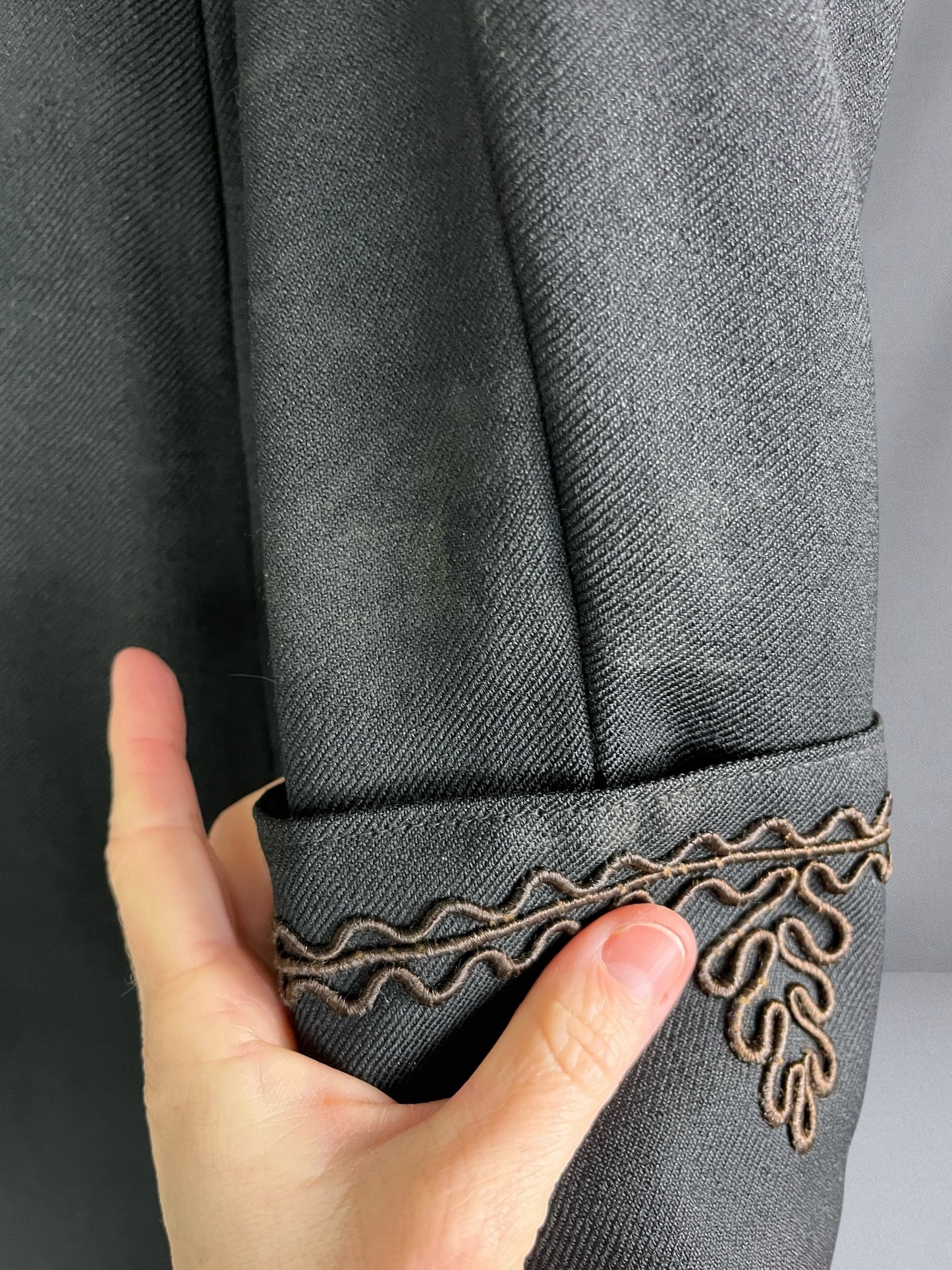 close-up of soutache trim cuff and surface soiling