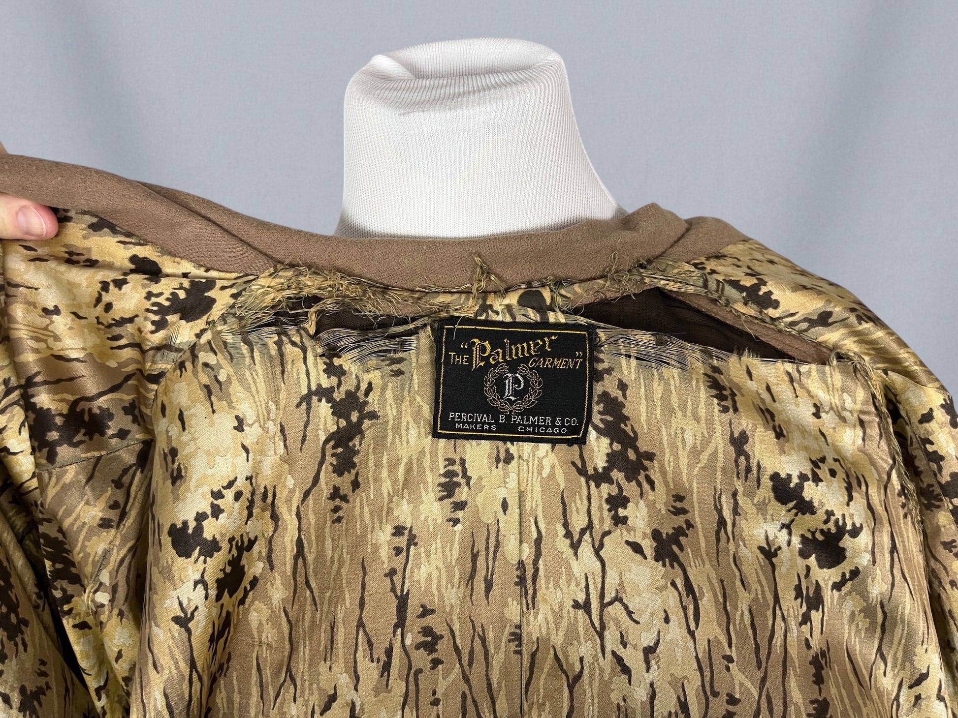 Interior silk lining & label image showing wear/tear to lining