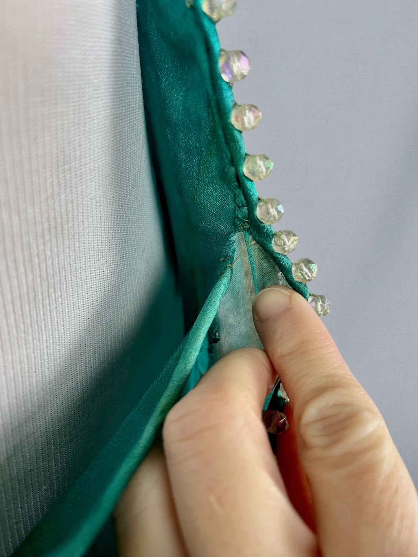 Close-up of tiny tear to solid silk at underarm side seam