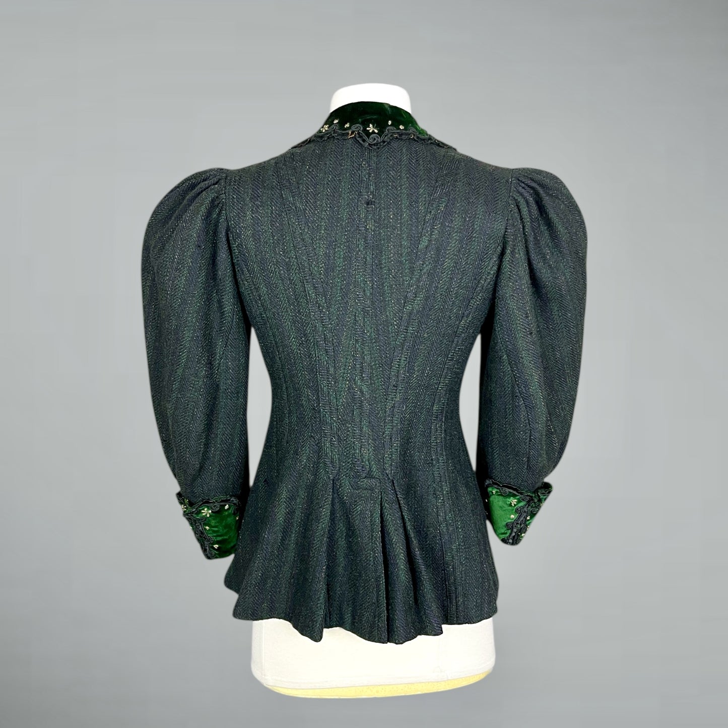 1890s leg of mutton sleeve jacket  on a mannequin against a gray background