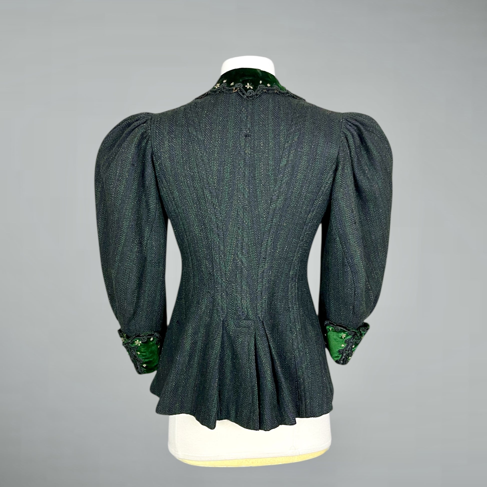 1890s leg of mutton sleeve jacket  on a mannequin against a gray background